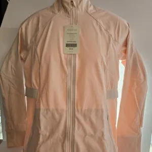 Fabletics Trinity Performance Jacket Size XL Rosy Tan
